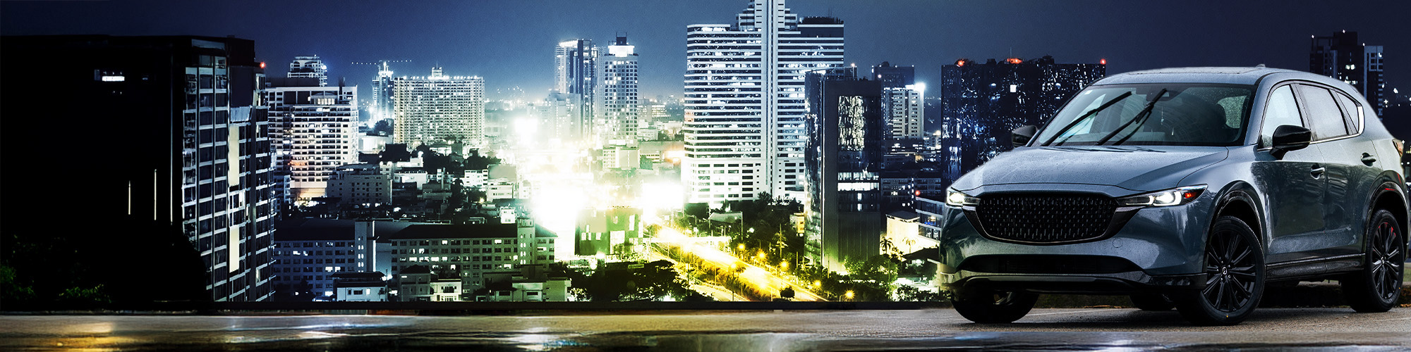 SUV con neumáticos Blackhawk Agility AWT frente a skyline nocturno sobre calles mojadas